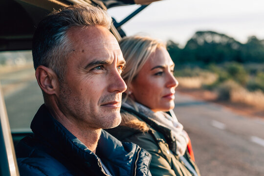 Couple Enjoys Sunset View From Open Car Trunk