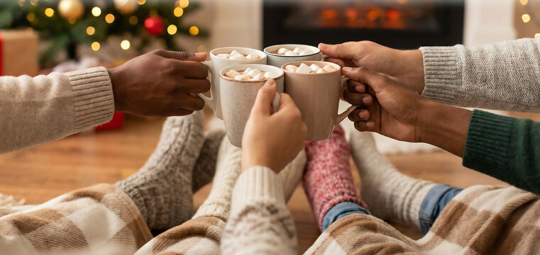 Cozy winter celebration with friends sharing hot cocoa in front of a warm fireplace, creating joyful memories during the holiday season