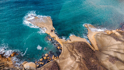 Aerial view of the coast with sandstone cliffs and turquoise sea. Summer vacation destination.