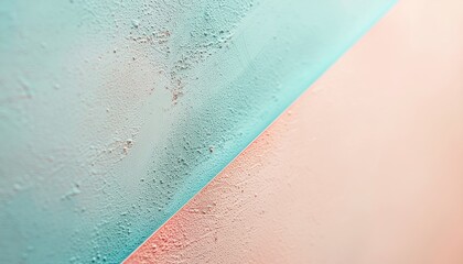 Close up abstract diagonal split of textured pastel blue and pink surfaces with speckled detail