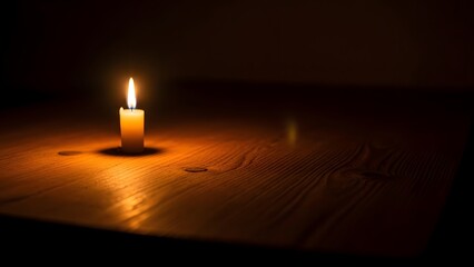 A single candle casts a warm glow across a wooden surface in the darkness, Simple charm of candlelight on wood for peace and comfort