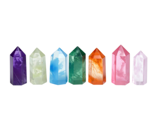Collection of seven polished, crystal points in a rainbow of colors against a black backdrop