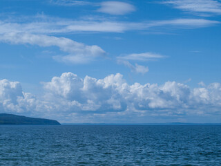 Obraz premium Scenic View of Blue Water and Cumulus Clouds