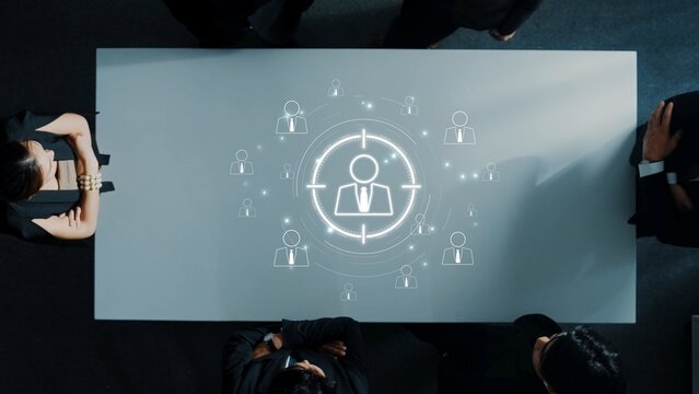 A business meeting depicting a strategic approach to targeting ideal customers, enhanced by a graphic illustration displaying human figures in focus. Raster