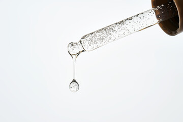 Cosmetic pipette dispensing serum creating a perfect drop