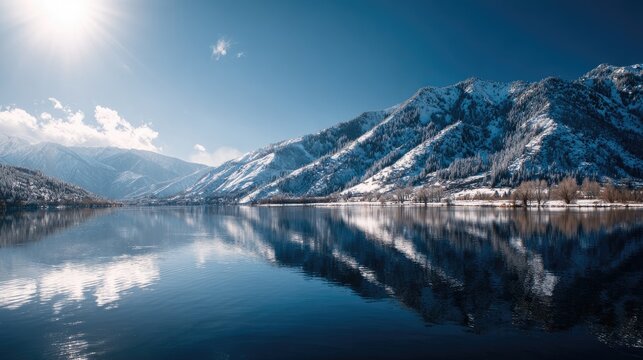 Snow-capped mountains reflecting on a tranquil lake under clear blue sky - Powered by Adobe