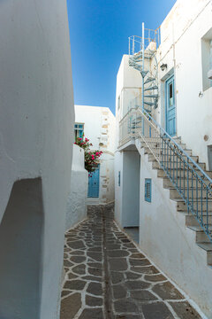 Narrow alleyway in the traditional rustic whitewashed greek sugar cube historic center of Parkia on Paros in the Cyclades