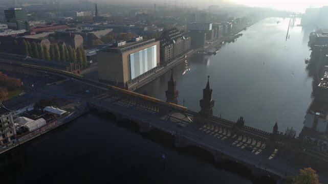 The Oberbaum Bridge, Oberbaumbrucke in Kreuzberg, a double-deck bridge crossing River Spree in Berlin, Germany. Aerial at Sunrise Morning Time.