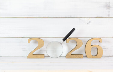 2026 New Year Goals Concept with Dartboard Target in Center Magnified Focus: New Year Concept with Magnifying Glass