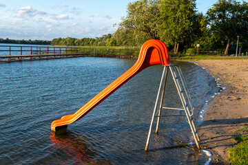 Water slide at lake beach during summer evening