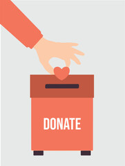 A hand places a heart into a donation box with the word "DONATE" on it, symbolizing charity and giving.