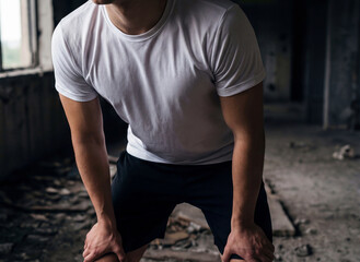 Men's e-sports T-shirt mockup in an abandoned location
