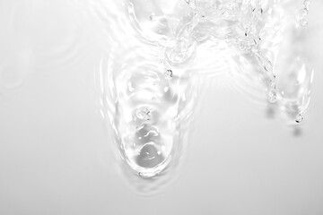 Clear Water Splash with Droplets on Soft White Background