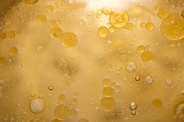 Close-Up of Bubbles in Golden Liquid with Soft Light Reflections