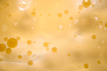 Abstract Yellow Background with Floating Bubbles and Light Reflection