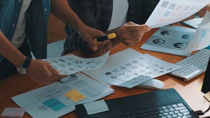 Top view of project manager looking at screen while designer writing idea. Close up of smart...