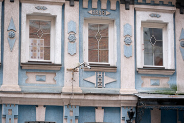 Unique architectural details of a historic blue building from 1898