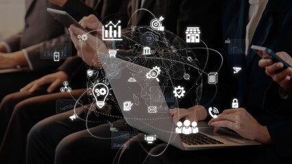 A group of professionals engaged in a conference, utilizing laptops and smartphones, showcasing global connectivity and data visualization in a modern, collaborative environment. Raster