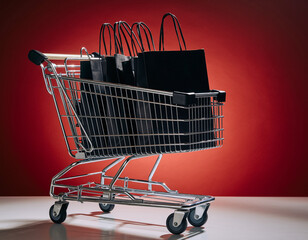 Shopping Cart Filled with Black Shopping Bags on Red Background