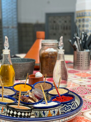 Colorful Moroccan spices in the traditional Marrakech kitchen, in patterned bowls on a table