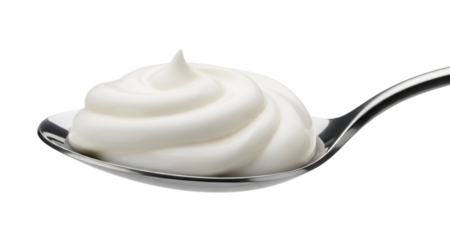 White cream swirl on a silver spoon isolated on white background dairy