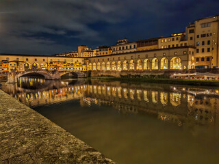 View of Ponte Vecchio in Florence, a medieval stone bridge lined with charming jewelry shops, offering stunning views of the Arno River and a lively atmosphere that captures the city&rsquo;s historic charm