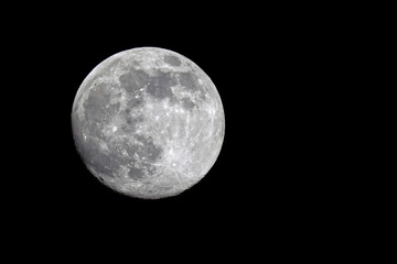 Bright full moon against black sky of space. 