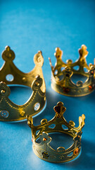 banner of Three gold crowns on blue background, symbol of Tres Reyes Magos ( Three Wise Men) who come bringing gifts for the kids on Epiphany or Dia de Reyes Magos, copy space