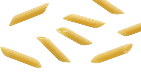 Scattered penne rigate pasta tubes on a colorful striped background dry pasta food