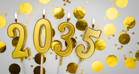 New Year greeting card. background Happy New Year 2035. Golden candles with numbers of year 2035 on...