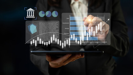 Business professional interacts with a tablet displaying dynamic financial charts and data, symbolizing growth and analysis in a fast-paced corporate environment. Gantry