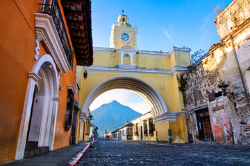 The Santa Catalina arch and Fuego volcano in Antigua Guatemala city, Guatemala