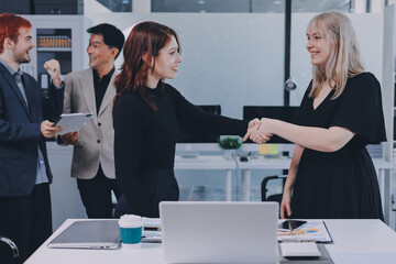 Fototapeta premium Meeting, partnership and business people shaking hands in the office for a deal, collaboration or onboarding. Diversity, professional and employees with handshake for agreement, welcome or greeting.