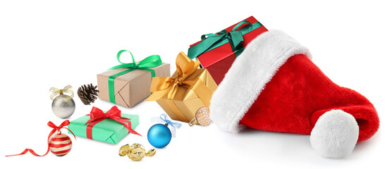 Gift boxes, Christmas ornaments and red Santa hat on white background