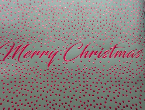 Sfondo grigio con palline rosse e con la scritta Merry Christmas