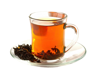 A glass mug filled with dark tea on a saucer with loose leaves, all isolated against black