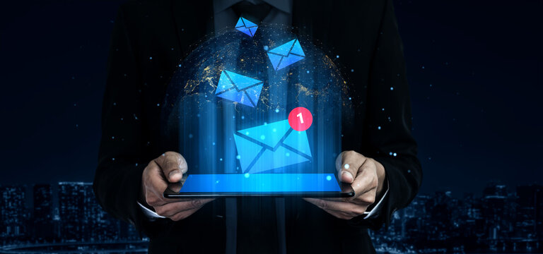 A modern businessman interacts with a tablet displaying email notifications, showcasing the intersection of technology and communication in a vibrant urban setting. Gantry
