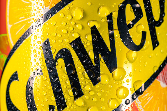 Background from a fragment of the Schweppes logo covered with water drops