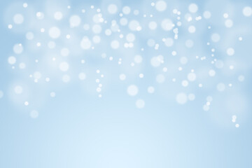 Fototapeta premium Soft blue bokeh background with glowing light particles, perfect for Christmas, winter holidays, posters, invitations, social media posts, festival designs.