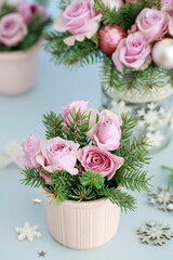 Modern Christmas pink decoration with roses, fir and baubles. Postcard motif.