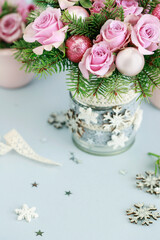Modern Christmas pink decoration with roses, fir and baubles. Postcard motif.
