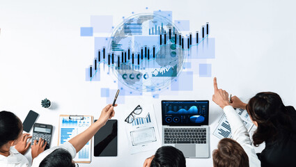 A business team collaborates on analyzing financial data using technology and visual aids. They explore strategies and insights in a modern office environment. Scalp