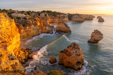 Marinha Beach, Sea Stacks, Cliffs and Atlantic Ocean in Sunny Morning. Lagoa, Algarve, Portugal. Golden Hour
