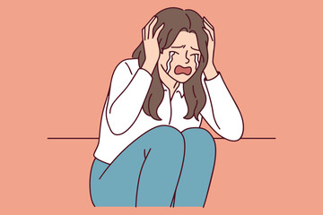 Scared girl suffers from anxiety and depression while hiding from noise. Concept of PTSD, mental disorder, deep sadness and emotional burnout.