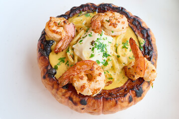 Shrimp pasta served in roasted pumpkin bowl