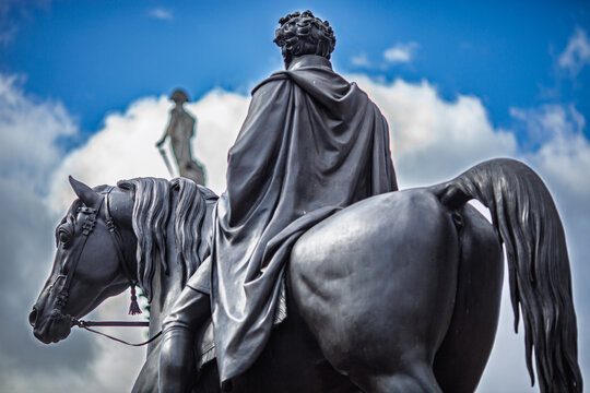 Statue of George IV with Nelson's column in Trafalgar Square, London