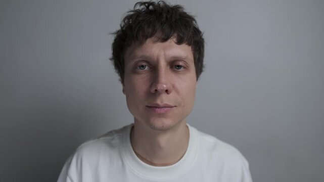 Man trying to hide anxiety with a forced smile