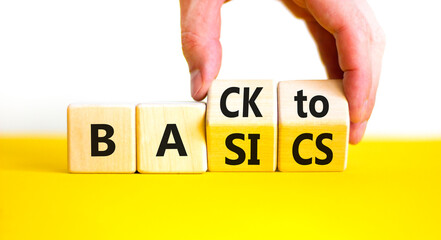 Back to basics symbol. Concept words Back to basics on wooden block. Beautiful yellow table white background. Businessman hand. Business back to basics concept. Copy space.