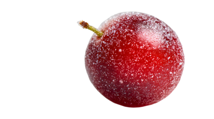 Close up of a single cherry covered in white specks against a black background in a studio shot