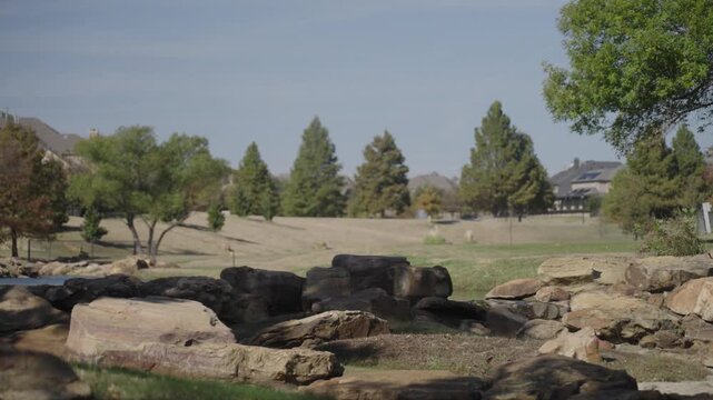 A small river flows among rocks in a Texas city park on a sunny December day.
